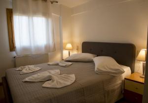 a bedroom with a bed with towels on it at Maisonette House Minos in Heraklio