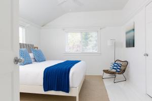 a white bedroom with a bed and a chair at Blue - Inn on the Beach in Newburyport +51 photos