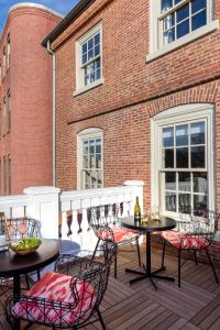 a patio area with chairs, tables and chairs at The Merchant in Salem