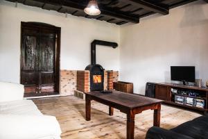 a living room with a wood stove in a room at Bagoly lak in Mátraszentimre