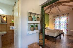 a bedroom with a bed and a bathroom at Ilyessa Cottages in Meson Yerakarion