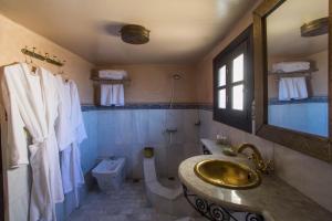 a bathroom with a toilet a sink and a bath tub at Riad Fes Bab Rcif & spa in Fez