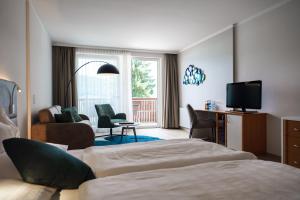 Televízia a/alebo spoločenská miestnosť v ubytovaní Seehotel Vinzenz