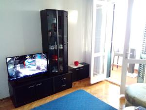 a living room with a tv and a entertainment center at Apartment Golden View in Dubrovnik