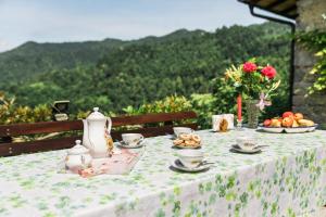 a table with a table cloth with food on it at Počitniška hiša Pologar in Tolmin