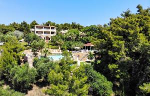 an aerial view of a resort with a pool and trees at Sanidiamonds in Sani Beach