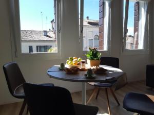 a table with fruit on it in a room with windows at Ca' dell'Angelo in Chioggia