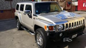 a white jeep parked in a parking lot at Apartment СкайХаус 63 in Chişinău