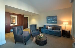 a living room with blue chairs and a couch at The Boathouse in Kennebunkport