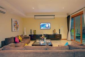 a living room with a couch and a tv at O Villas Seminyak - 2026 Earlybirds ON SALE! in Seminyak