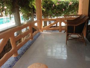 a porch with a wooden fence and a chair at Paradise Bungalows in Haad Rin