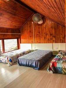 Tempat tidur dalam kamar di Pousada Paraiso do Alto