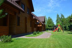a playground in front of a building with a play structure at Cooper House in Szack