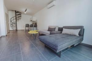a living room with a couch and a table at River View Boutique Apts in Ayia Napa