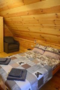 a bedroom with a bed and a chair in a room at Cooper House in Szack