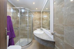a bathroom with two sinks and a shower at Haraki Sea View Luxury House in Rhodes Town +16 photos
