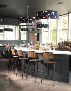 a kitchen with a large bar with stools at The Boathouse in Kennebunkport