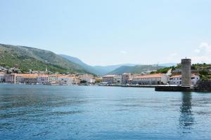 a large body of water with a town and buildings at Apartment Tena in Senj