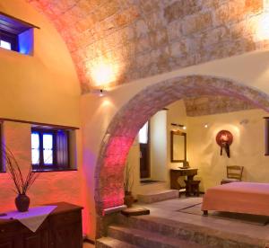 a bedroom with an archway and a bed in a room at Ardamis in Monemvasia