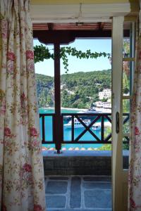 a window with a view of the water at Liadromia Hotel in Patitiri
