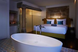 Uma cama ou camas num quarto em Convento do Seixo Boutique Hotel & Spa