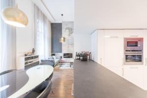 a white kitchen with a large counter top in a room at Apartment in Andrássy Avenue in Budapest