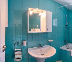 a blue tiled bathroom with a sink and a mirror at Villa White Dove in Golden Sands +83 photos