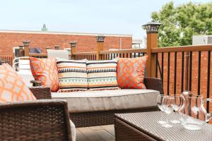 a couch on a balcony with a table and chairs at MTLVacationrentals-The MTLVR Kisses in Montreal