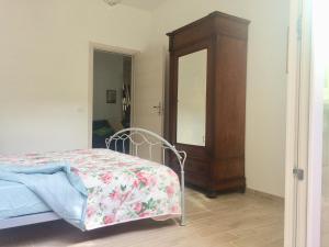 a bedroom with a bed with a dresser and a mirror at CasaLella in Viareggio