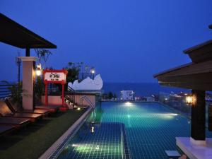 a swimming pool on top of a building at night at Chalelarn Hotel Hua Hin in Hua Hin +64 photos