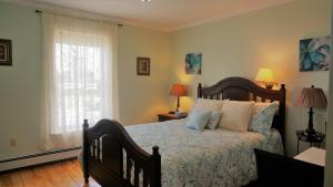 a bedroom with a bed and a window at Inn on the Harbour in Charlottetown