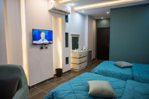 a room with two beds and a tv on a wall at Hayat Pyramids View Hotel in Cairo