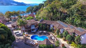 an aerial view of a house with a swimming pool at Hotel Praia do Portinho in Ilhabela