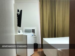 a bedroom with a white bed and a mirror at Nox Apart Hotel - Garvey in Brasilia +28 photos