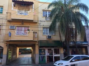 a building with a palm tree in front of it at departamento centro in La Rioja
