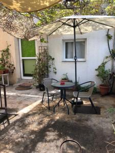 a patio with a table and chairs and an umbrella at Lucky 5 in Paralimni
