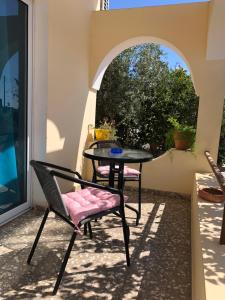 a table and chairs on a patio with a window at Lucky 5 in Paralimni