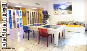 a room with a table with chairs and a tv at Duomo Luxury House 9 Pax in Milan