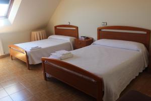 En eller flere senge i et værelse på O Cruceiro