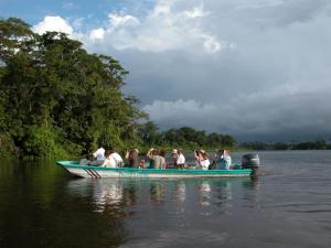 a group of people in a boat on the water at Pachira Lodge in Tortuguero