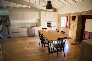 a kitchen and dining room with a table and chairs at Casa da Teresina in Sistelo