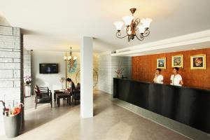 a dining room with people sitting at a table at Samkong Place in Phuket