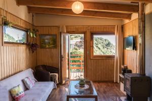 ein Wohnzimmer mit einem Sofa und einem Tisch in der Unterkunft Cabañas La Misión in Niebla