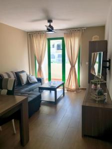 a living room with a couch and a table at Playa Muchavista lovely ground floor apartment in El Campello