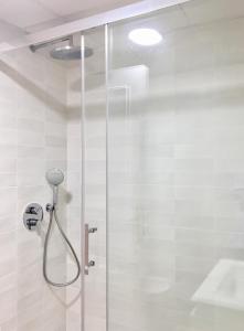 a shower with a glass door in a bathroom at Playa Muchavista lovely ground floor apartment in El Campello