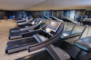 a gym with a bunch of treadmills and ellipticals at Banyan Tree Shanghai On The Bund in Shanghai
