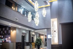 a lobby with a chandelier hanging from the ceiling at Pueblo Amigo Hotel Plaza y Casino in Tijuana