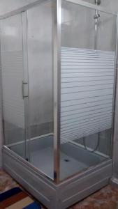 a glass shower enclosure with white blinds in a room at Villa House Georgia in Tbilisi City +31 photos