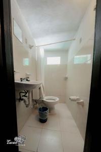 a bathroom with a sink and a toilet at ECO-CABAÑAS Cancún in Cancún