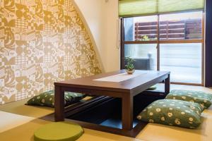 a room with a table and a chair and a window at Bijou Suites Kakomi in Osaka +36 photos